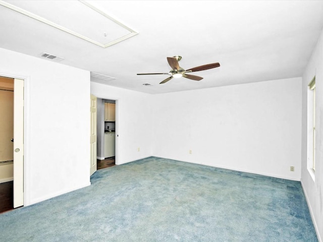 empty room featuring dark carpet and ceiling fan