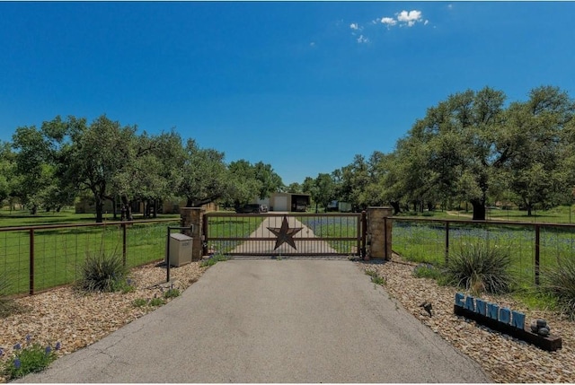 view of gate featuring a lawn