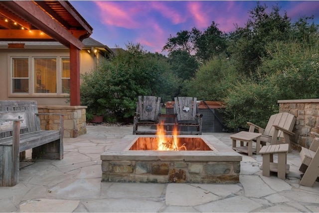 patio terrace at dusk with a fire pit