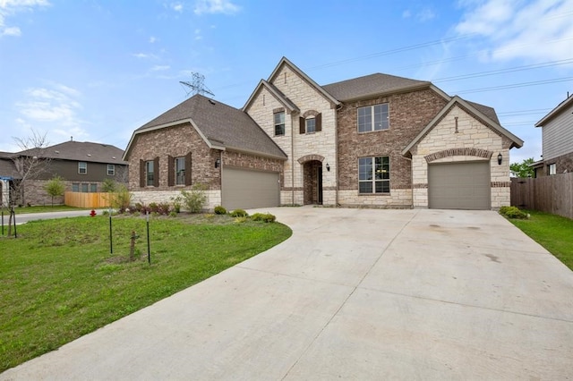 french country style house with a garage and a front lawn