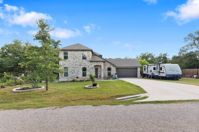 view of front of house with a garage and a front lawn