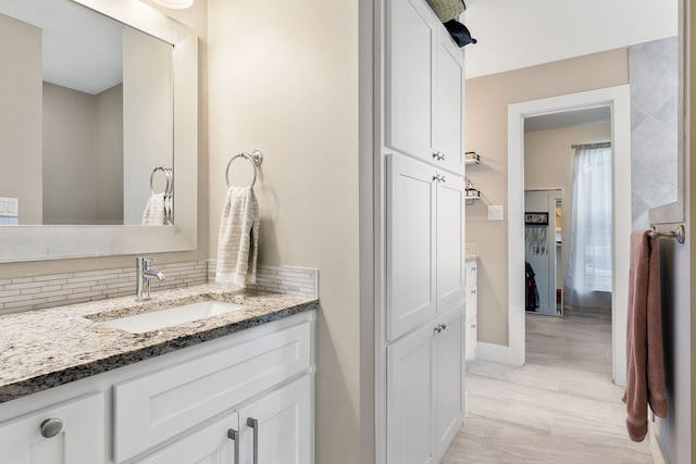 bathroom with vanity and backsplash