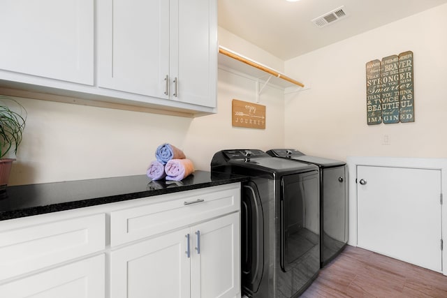 washroom with cabinets and independent washer and dryer