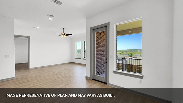 unfurnished room with ceiling fan and light wood-type flooring