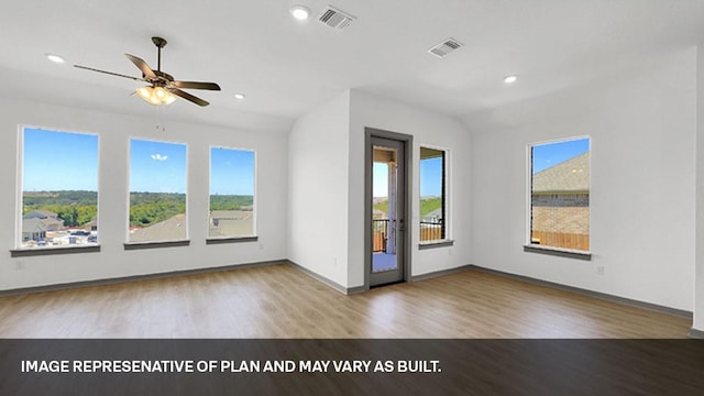 unfurnished room with hardwood / wood-style flooring, lofted ceiling, and ceiling fan