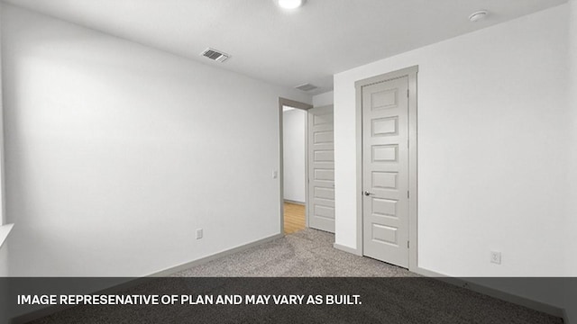 unfurnished bedroom with light colored carpet