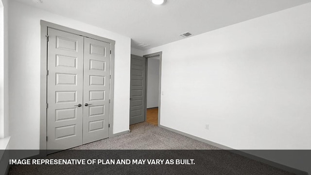 unfurnished bedroom featuring light carpet and a closet