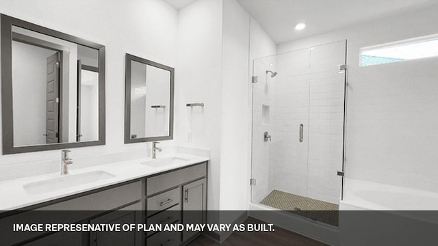 bathroom featuring hardwood / wood-style floors, vanity, and plus walk in shower