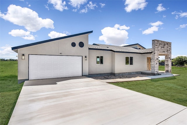 view of front of home featuring a garage and a front lawn