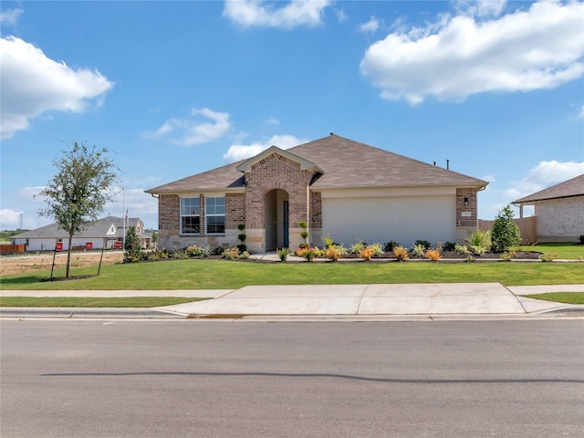 ranch-style home with a front lawn and a garage