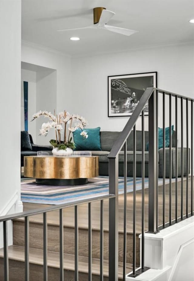 stairway featuring crown molding and ceiling fan