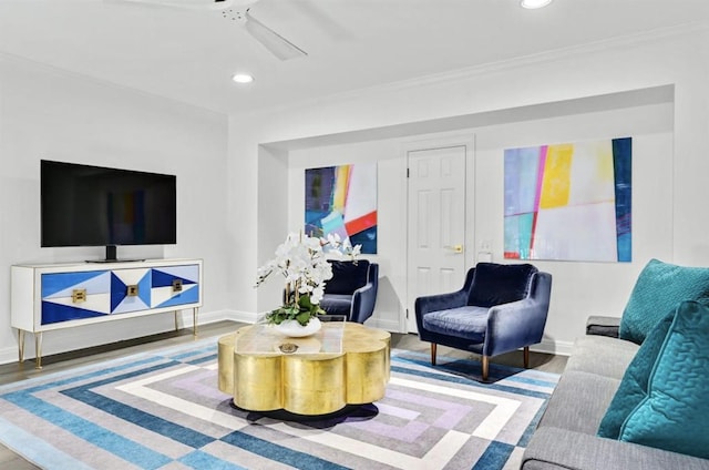 living room with ceiling fan, hardwood / wood-style floors, and crown molding