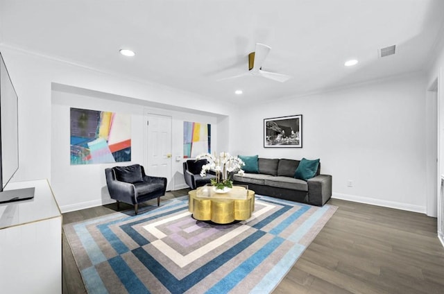 living room featuring ceiling fan and dark hardwood / wood-style flooring