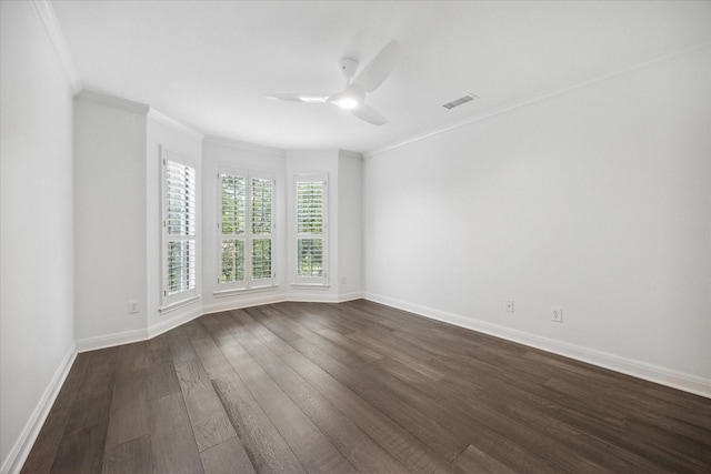 empty room with crown molding, ceiling fan, and dark hardwood / wood-style flooring