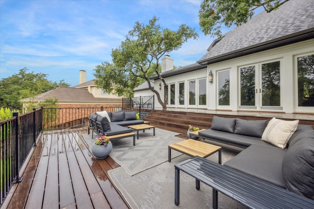 wooden deck with an outdoor living space and french doors