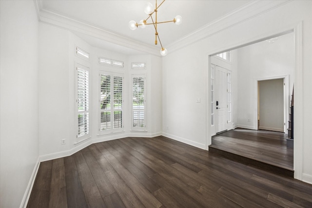 unfurnished room featuring a notable chandelier, ornamental molding, and dark hardwood / wood-style flooring