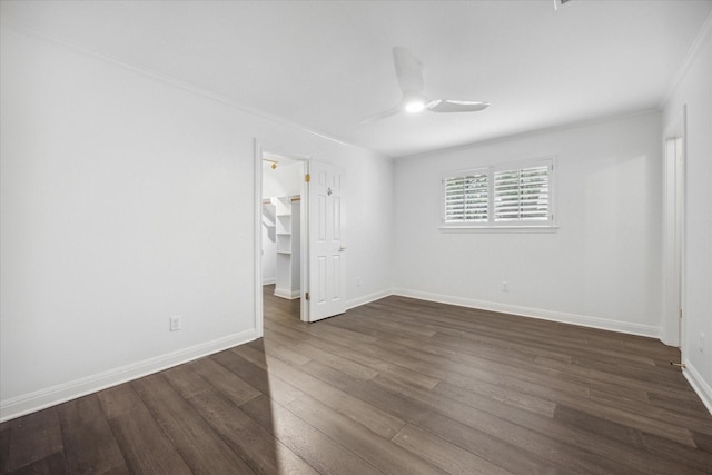 empty room featuring crown molding, dark hardwood / wood-style floors, and ceiling fan