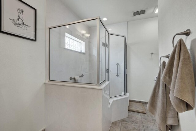 bathroom featuring recessed lighting, visible vents, baseboards, and walk in shower