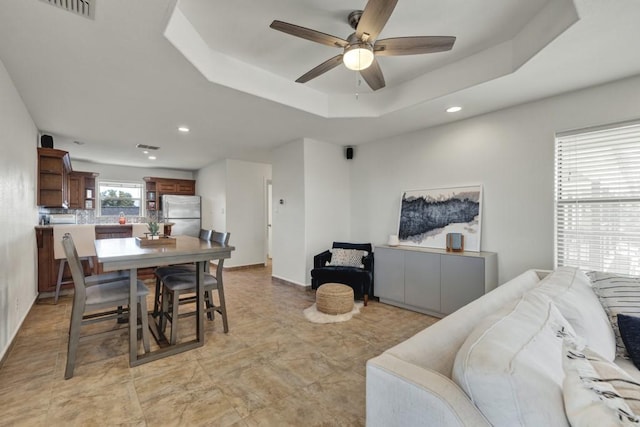 dining space featuring ceiling fan, visible vents, a raised ceiling, and recessed lighting