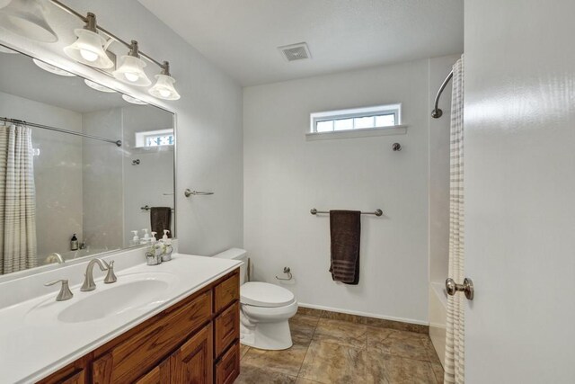 full bathroom featuring baseboards, visible vents, vanity, and toilet