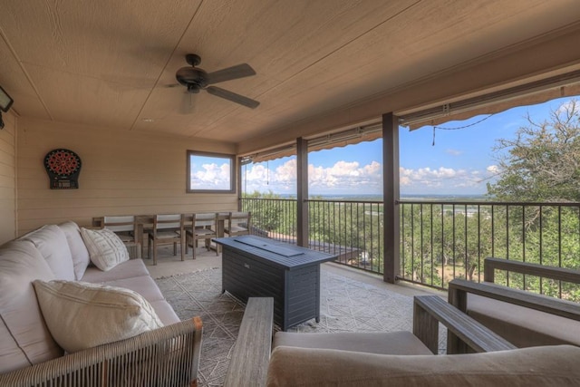 sunroom featuring wooden ceiling and ceiling fan