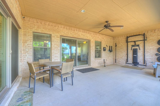 view of patio with outdoor dining area and a ceiling fan