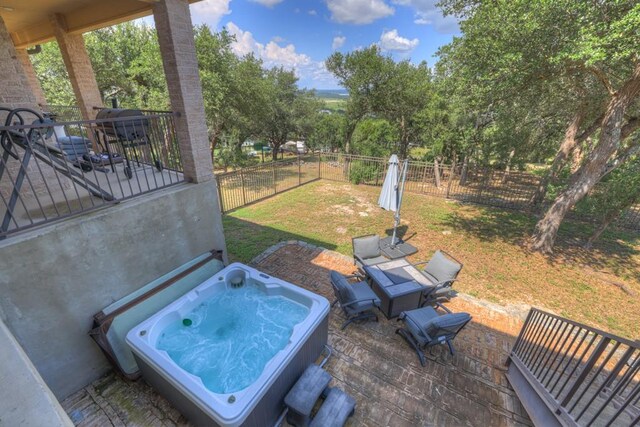 view of patio with fence and an outdoor hot tub