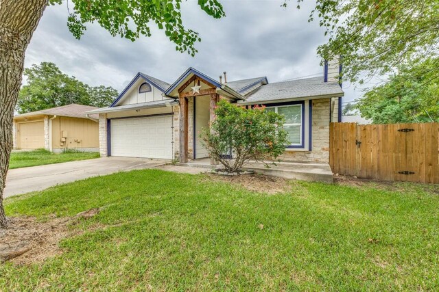 view of front of property with a garage and a front yard