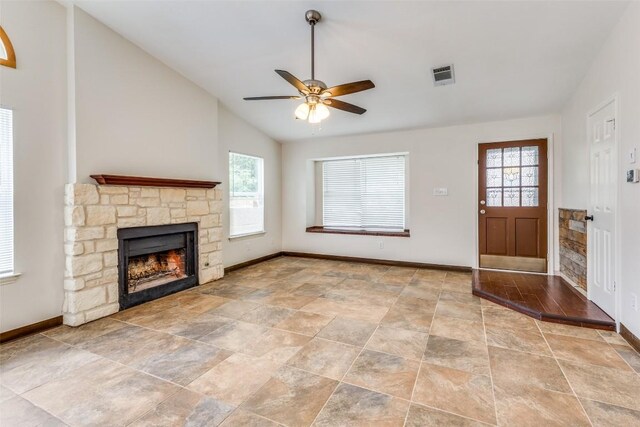 unfurnished living room with light tile patterned flooring, a fireplace, ceiling fan, and vaulted ceiling