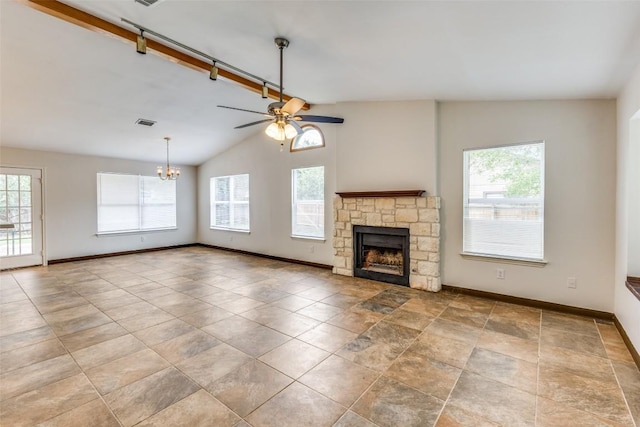 unfurnished living room featuring lofted ceiling with beams, a healthy amount of sunlight, ceiling fan with notable chandelier, and a fireplace