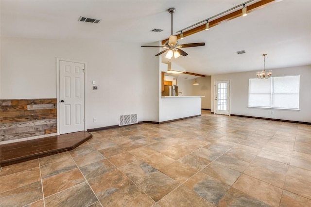 unfurnished living room with lofted ceiling and ceiling fan with notable chandelier