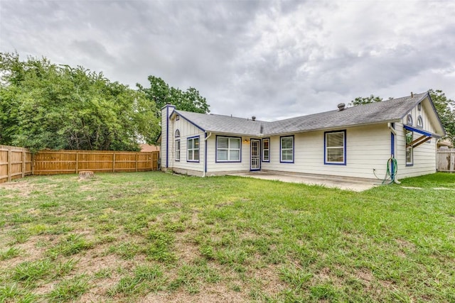 rear view of house with a patio area and a lawn