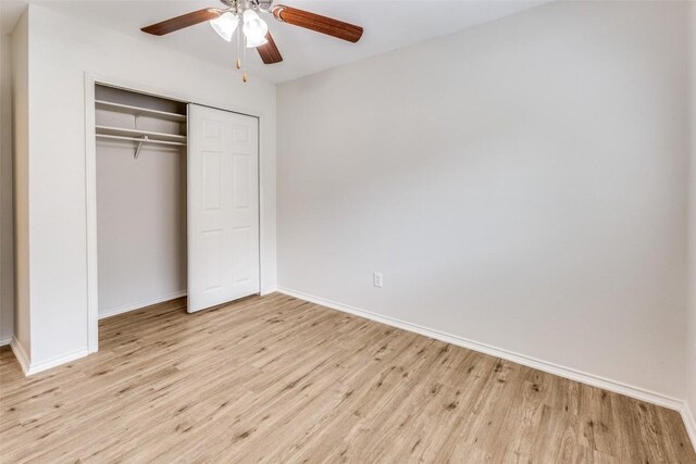 unfurnished bedroom featuring light hardwood / wood-style flooring, a closet, and ceiling fan