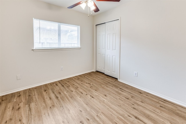 interior space featuring light wood-type flooring, ceiling fan, and a closet