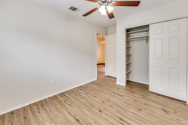 unfurnished bedroom featuring light hardwood / wood-style flooring, a closet, and ceiling fan