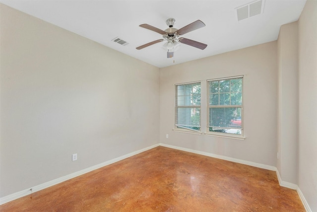 spare room featuring concrete floors and ceiling fan