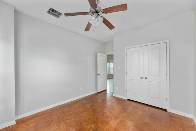 unfurnished bedroom with concrete floors, ceiling fan, and a closet