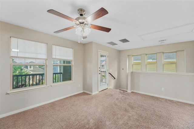 unfurnished room with light colored carpet and plenty of natural light