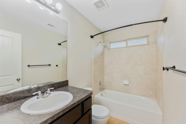 full bathroom with vanity, tiled shower / bath, tile patterned floors, and toilet