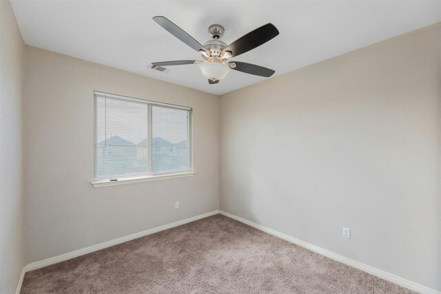 carpeted empty room featuring ceiling fan