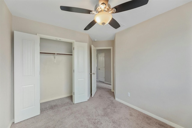 unfurnished bedroom with light carpet, a closet, and ceiling fan