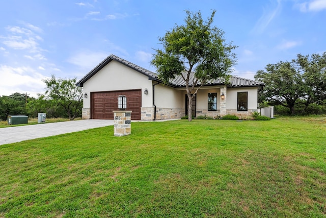 view of front of house with a garage and a front lawn