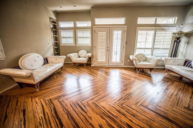 unfurnished room featuring parquet floors, french doors, and a healthy amount of sunlight