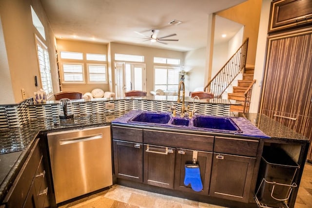 kitchen featuring sink, dishwasher, ceiling fan, dark stone countertops, and dark brown cabinetry