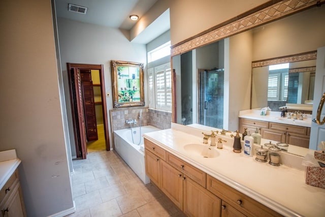 bathroom featuring vanity and shower with separate bathtub