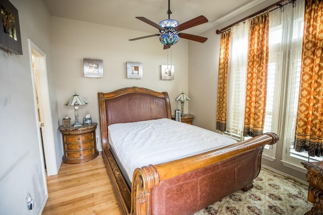 bedroom with ceiling fan and light hardwood / wood-style flooring