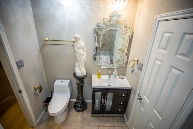 bathroom featuring vanity, tile patterned flooring, and toilet