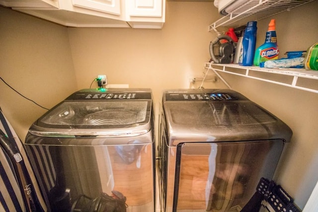 laundry area featuring cabinets and washer and clothes dryer