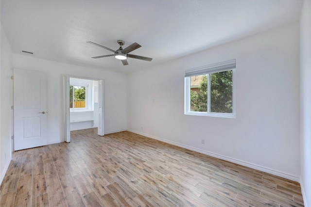 empty room featuring ceiling fan and light wood-type flooring