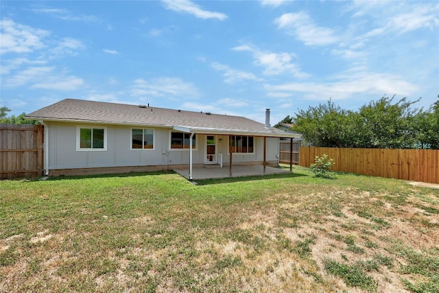 rear view of house with a lawn and a patio area